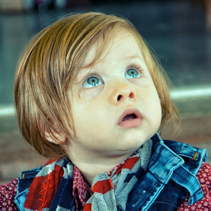 Big blue eyes baby looking up scarf winter