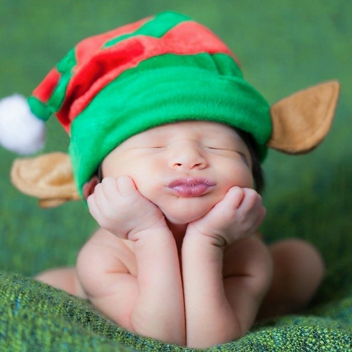 Cute baby elf costume chin on hands green