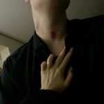 Hand on chest dark lighting neck mark skin view