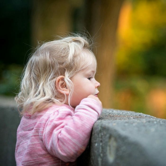Love cute baby images girl looking over wall outdoor