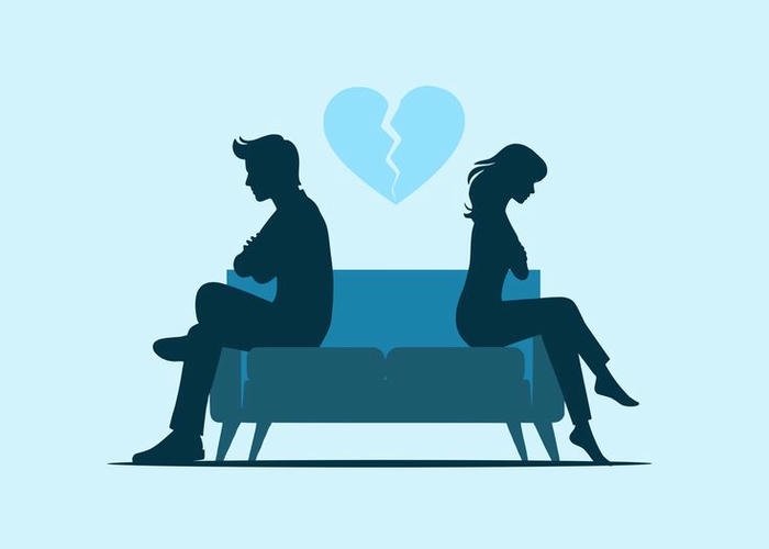 Sad couple sitting back to back blue bench.