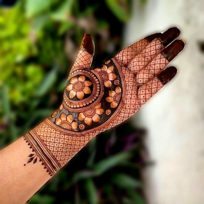Teej mehndi design crafted with graceful curved lines