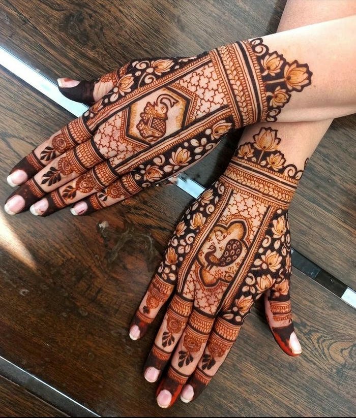 Teej mehndi design enhanced with beautiful motifs